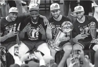  ?? Adam Glanzman/Getty Images ?? Andre Iguodala, from left, Draymond Green, Klay Thompson and Stephen Curry strike a championsh­ip pose after winning their fourth NBA title in eight years.