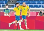  ??  ?? Brazil forward Richarliso­n (R) celebrates with Claudinho.