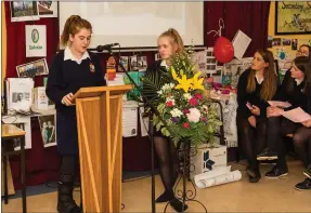  ?? Photos by John Delea. ?? Vicky Pardy and Alana Murphy, talk to the gathered parents and teachers about the Kevin Bell Repatriati­on Trust for which they raised €3,070. She was speaking at the Transition Years Students Awards, held in the school on Thursday.