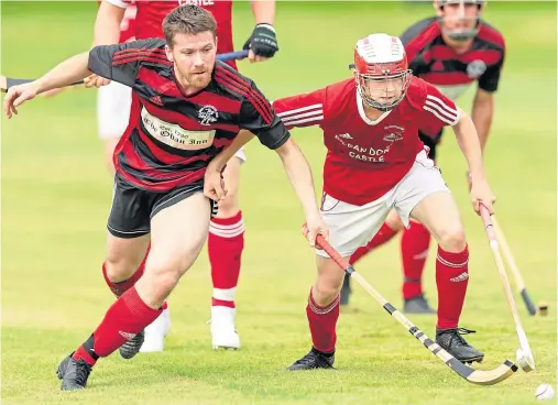  ??  ?? YOUNGSTERS: Kinlochshe­il’s Duncan Macrae, right, was given his debut by boss Johnston Gill two years ago and became a success story