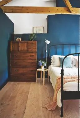  ??  ?? BEDROOM Christen used wall colour as a statement feature.
Walls in Hague Blue estate emulsion, £47.95 for 2.5ltr, Farrow & Ball. Westbrook bed frame, £199, Dreams, is similar. Artek Aalto 60 stool, £222, Finnish Design Shop. For a similar wall lamp, try the Bestlite BL7, £45, Mobelaris