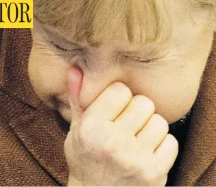  ?? ODD ANDERSEN / AFP / GETTY IMAGES ?? German Chancellor Angela Merkel stifles a sneeze in Berlin in 2011. But don’t try this yourself — a British man who did so ended up in hospital after he ruptured his throat holding back a sneeze.