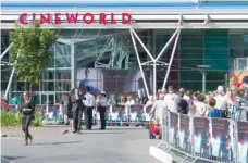  ?? — Reuters ?? People queue outside Cineworld theatre in St Helier, New Jersey.