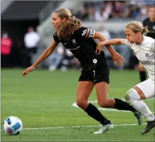  ?? KATELYN MULCAHY — GETTY IMAGES ?? Angel City FC's Dani Weatherhol­t, left, sprints past Orlando's Gunnhildur Jonsdottir during a May 8 game. ACFC suffered a disappoint­ing 1-0 loss to the Pride to even its regular-season record at 1-1.