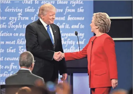  ?? ROBERT DEUTSCH, USA TODAY ?? Hillary Clinton greets Donald Trump on stage during the first presidenti­al debate.