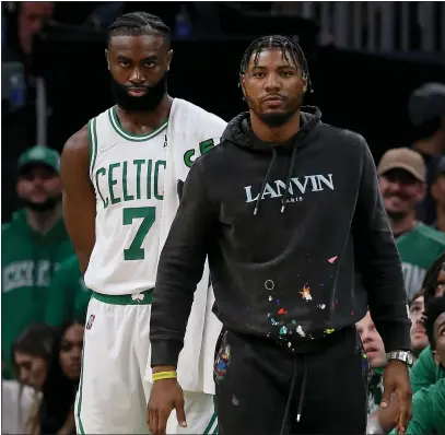  ?? MATT STONE / BOSTON HERALD ?? Jaylen Brown and injured Marcus Smart watch from the sidelines in the first half of Game 4 on Monday night.