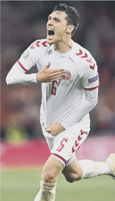  ??  ?? 0 Denmark defender Andreas Christense­n celebrates after scoring his team’s third