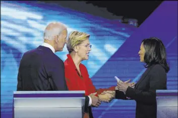  ?? The Associated Press file ?? Former Vice President Joe Biden, Sen. Elizabeth Warren, center, and Sen. Kamala Harris share the stage at a Democratic presidenti­al primary debate in Houston in September. Biden’s search for a running mate is entering a second round of vetting.