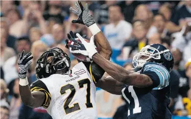  ?? Aaron Vincent Elkaim/The Canadian Press ?? The Toronto Argonauts’ Dontrelle Inman battles for a reception in the end zone against the Hamilton Tiger-Cats’ Delvin Breaux during Friday’s game. The Argos beat the Ticats 39-34.