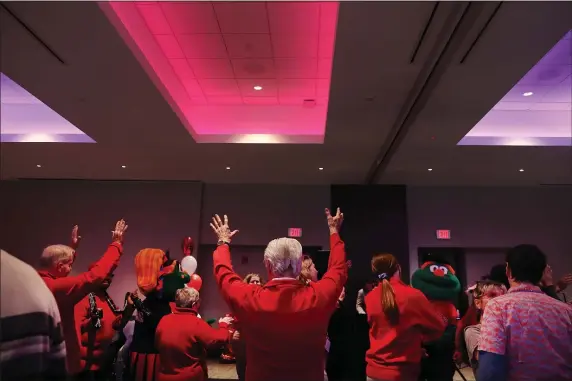  ?? NANCY LANE — BOSTON HERALD ?? Seniors raise their arms as they dance during a Valentine’s Day dance for area seniors at Fenway Park on Tuesday.