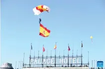  ?? XINHUA PHOTO ?? COMMERCIAL PARTNERSHI­P
A paratroope­r displays the Spanish national flag during the National Day celebratio­n in Madrid, Spain, on Oct. 12, 2023. Businesspe­ople and officials from Spain and China are urging both countries to strengthen their commercial ties further and increase investment.