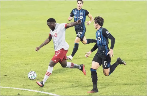  ?? Graham Hughes / Associated Press ?? Toronto FC’s Jozy Altidore, left, scores a goal against Montreal on Sept. 9. The U.S. national team star has been cleared for Toronto FC’s first game at Rentschler Field on Sunday night.