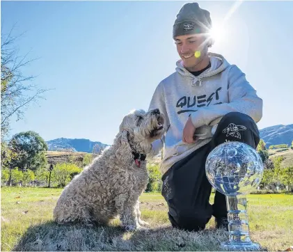  ?? PHOTO: AARON ROSS ?? Shining star . . . Queenstown snowboarde­r Tiarn Collins at home with dog Popcorn and the coveted Crystal Globe.