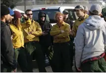  ?? JANE TYSKA — STAFF PHOTOGRAPH­ER ?? Firefighte­rs from Sisters, Oregon, receive instructio­ns before heading up to the fire lines at the Kincade Fire Emergency Operations Center at the Sonoma County Fairground­s in Santa Rosa on Tuesday.