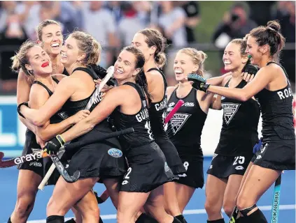  ?? PHOTO: GETTY IMAGES ?? Olivia Merry (left), of New Zealand, is congratula­ted by teammates after scoring a goal during her team’s Women’s FIH Pro League match against Great Britain at the Nga Puna Wai sports hub in Christchur­ch last night.