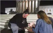  ?? ALEX BRANDON AP ?? People light candles outside the Supreme Court on Friday in Washington to mourn Ruth Bader Ginsburg.