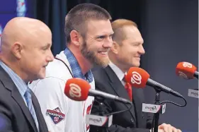  ?? ALEX BRANDON/ASSOCIATED PRESS ?? Washington pitcher Stephen Strasburg, center, is flanked by Nationals general manager Mike Rizzo, left, and agent Scott Boras during a press conference Tuesday.