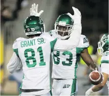  ?? PETER POWER/THE CANADIAN PRESS ?? Roughrider­s wide receiver Devon Bailey, right, celebrates his touchdown with teammate Bakari Grant during Friday’s game against the Tiger-Cats in Hamilton. The Riders won 27-19.