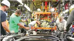  ?? —Reuters ?? Workers assembling a Ford truck at the Ford truck plant in Louisville.