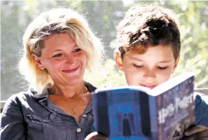  ??  ?? Theo Galkin, 8, rereads a favorite part of Harry Potter and the Sorcerer’s Stone with his mother, Chloe Galkin, at their home in South Orange, N.J. As the 20th anniversar­y of the initial publishing of the first Harry Potter book is celebrated this...