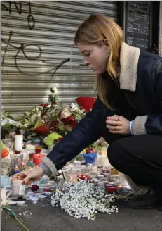  ??  ?? Sorrow: A memorial to victims at La Belle Equipe, Paris