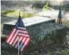  ?? RICARDO RAMIREZ BUXEDA/ORLANDO SENTINEL ?? Veterans graves are adorned with US Flags for Veterans Day at the Eatonville Memorial Garden Cemetery.