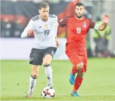  ??  ?? Azerbaijan’s midfielder Rahid Amirguliye­v (right) and Germany’s midfielder Leon Goretzka (left) vie for the ball during the Fifa World Cup 2018 qualificat­ion football match between Germany and Azerbaijan in Mainz, western Germany. — AFP photo