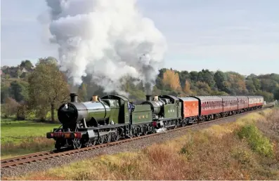  ?? NEIL HARVEY ?? GWR ‘28XX’ 2‑8‑0 No. 2857 and ‘42XX’ 2‑8‑0T No. 4270 pull away from Burrs Halt with the 1.50pm Heywood‑Rawtenstal­l train on October 20.