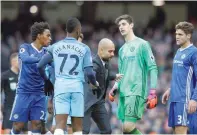  ?? — Reuters ?? Manchester City manager Pep Guardiola with Kelechi Iheanacho and Chelsea’s Thibaut Courtois at the end of the match.