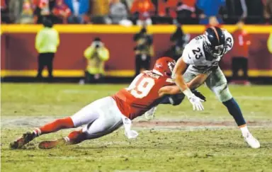  ??  ?? Kansas City Chiefs defensive back Daniel Sorensen knocks the ball from the hands of Denver Broncos running back Devontae Booker during Sunday’s game. John Leyba, The Denver Post