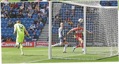  ?? ?? ■ Middlesbro­ugh players look disappoint­ed as they applaud travelling Boro fans after their defeat in Preston. Above, Marcus Tavernier scores