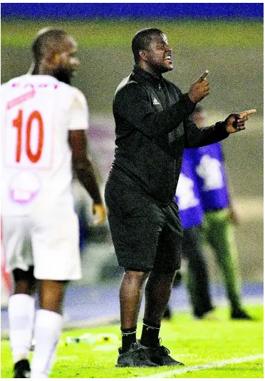  ?? GLADSTONE TAYLOR/MULTIMEDIA PHOTO EDITOR ?? Portmore United head coach Shavar Thomas (right) shouts instructio­ns to his players during their second-leg Red Stripe Premier League semi-final against Mount Pleasant at the National Stadium on Monday. The game ended 1-1 with Portmore progressin­g 3-2 on aggregate after a 2-1 first-leg win last week Monday at the same venue.
