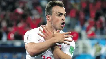  ?? — GETTY IMAGES ?? Switzerlan­d’s Xherdan Shaqiri was fined for this hand gesture against Serbia.