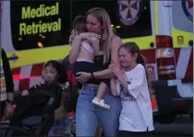  ?? RICK RYCROFT THE ASSOCIATED PRESS ?? People are led out of the Westfield Shopping Centre, where several people were stabbed, in Bondi Junction, Australia, on Saturday. Police said six people were killed and the suspect fatally shot.