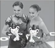  ?? Petr David Josek / AP ?? Gold medalist Alina Zagitova (right) celebrates with compatriot and silver medalist Evgenia Medvedeva.