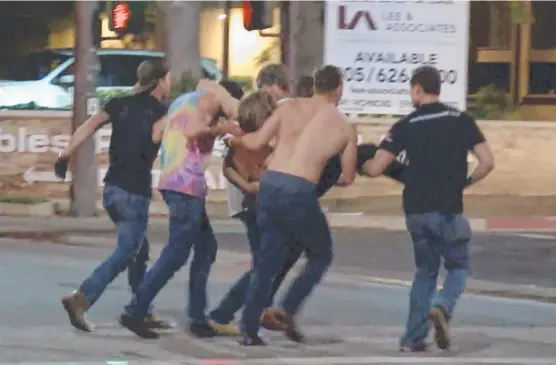  ?? SAVIOURS: A victim is carried from the scene of the shooting at the Borderline Bar & Grill in Thousand Oaks, California Picture: RMG News via AP ??