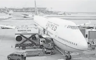  ?? Bill Montgomery / Houston Chronicle file ?? Workers prepare a United Airlines Boeing 747 for its departure from South Korea’s Incheon Internatio­nal Airport in 2013. “We’ll honor the 747 with an unforgetta­ble retirement celebratio­n,” United’s Scott Kirby says.