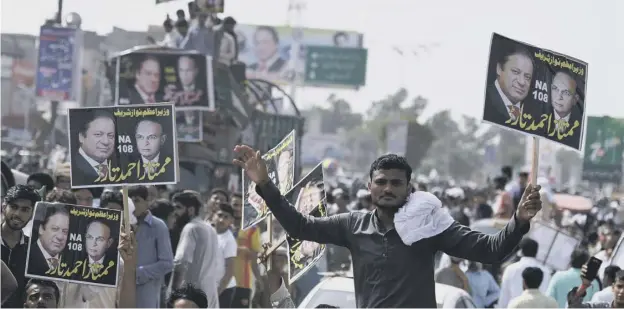  ??  ?? Supporters of Pakistani ousted prime minister Nawaz Sharif attend a rally in Gujrat city in Punjab province yesterday. The wife of Mr Sharif will attempt to win the seat he was forced to vacate when he was disqualifi­ed from office. The announceme­nt...