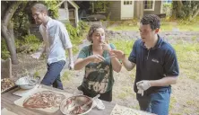  ?? TNS PHOTO ?? SWEET IDEA: Miles Bloch, Alissa Hartnid and Evan Smith, from left, make chocolate at a Moishe House event.