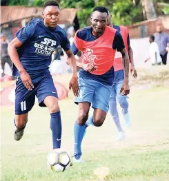  ?? CONTRIBUTE­D PHOTOS ?? Rivaldo English (left) of three-time defending champions Eurotrend, dribbles away from Dalton Slew of Ewarton, in the opening game of the SFP Waterhouse 6-a-side football competitio­n last Saturday. The game ended 0-0.