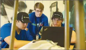  ?? (Arkansas Democrat-Gazette/Colin Murphey) ?? Henry Vannoi (from left), Harrison Cain and Isaac Hubberd of the Treble Makers team work on their project Sunday during the Make48 engineerin­g challenge competitio­n at the Innovation Hub in North Little Rock.