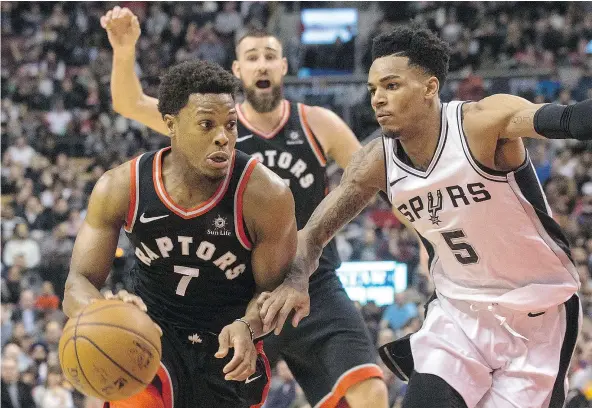  ?? — THE CANADIAN PRESS ?? Toronto Raptors guard Kyle Lowry, left, drives at San Antonio guard Dejounte Murray (5) in Toronto on Jan. 19. Lowry has been picked for the all-star game this year, his fourth time being chosen.