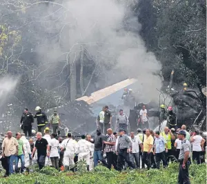  ?? Picture: AP. ?? Search and rescue workers at the scene of the crash.