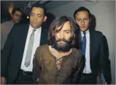  ?? THE ASSOCIATED PRESS ?? In this 1969file photo, Charles Manson is escorted to his arraignmen­t on conspiracy-murder charges in connection with the Sharon Tate murder case. Authoritie­s say Manson, cult leader and mastermind behind 1969deaths of actress Sharon Tate and several...