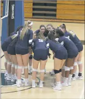  ?? STAFF PHOTO BY TED BLACK ?? Players from the La Plata High School volleyball team huddle one last time before the start of Wednesday’s Class 2A South Region Section II final match at Patuxent. The Warriors led 2-1 in sets but were eventually toppled by the Panthers in five.
