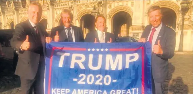  ??  ?? Support: DUP MPS Ian Paisley (left), Sammy Wilson (second left) and Paul Girvan (right) fly the flag for Donald Trump