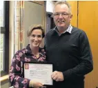  ?? PHOTO: JOSHUA WALTON ?? Lifesavers . . . Kate Rive receiving a certificat­e of appreciati­on from Detective Senior Sergeant Malcolm Inglis.