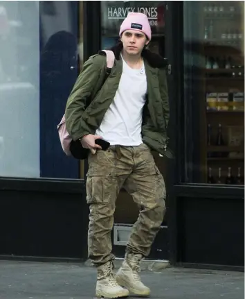  ??  ?? Free at last: Brooklyn Beckham was spotted having fun with friends without his sling on Thursday, heading to a north London Starbucks