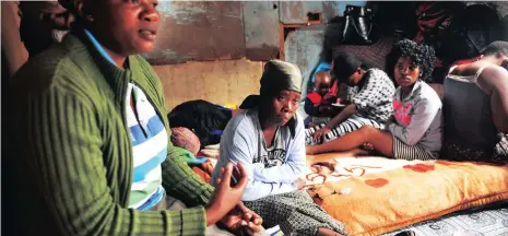  ?? Picture: PHANDO JIKELO ?? HEART-RENDING: Grieving and traumatise­d Nophelo Sofie Ngqiba, centre, who has lost a child and a grandchild to suspected food poisoning, is comforted by a relative Noncedo Fukuse.