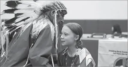  ?? -AP ?? Climate change environmen­tal activist Greta Thunberg receives hugs after speaking at a youth panel at the Standing Rock Indian Reservatio­n, North Dakota, USA.